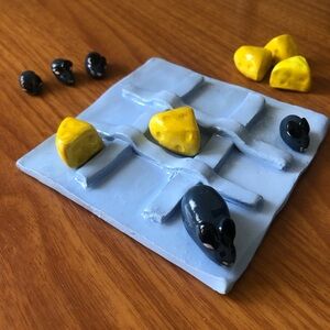 Blue Tic-Tac-Toe Game with Yellow Cheese and Black Mice